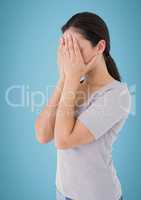 Woman hands on face against blue background