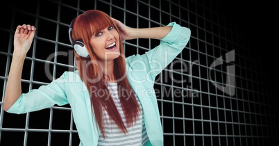 Woman dancing while enjoying music on headphones