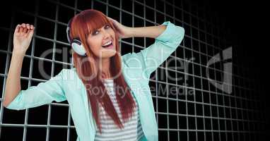 Woman dancing while enjoying music on headphones