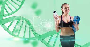 Woman holding yoga mat and water bottle against DNA structure