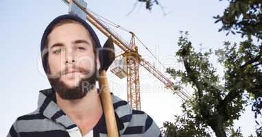 Hipster with ax against crane