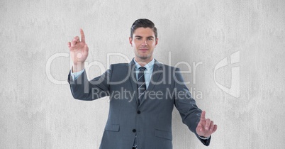 Portrait of businessman gesturing against gray background