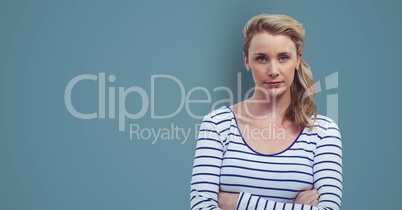 Confident female hipster standing arms crossed against blue background