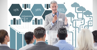 Businessman giving speech to colleagues against graphs
