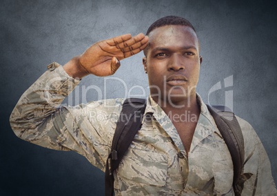Soldier saluting against navy background with grunge overlay
