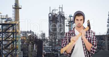 Male hipster holding ax at industry