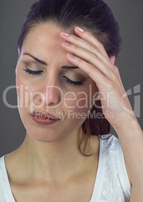 Stressed woman against grey wall