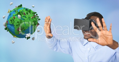 Happy businessman wearing VR glasses while gesturing by low poly earth