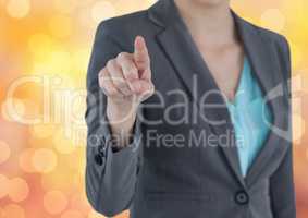 Midsection of female executive touching over bokeh