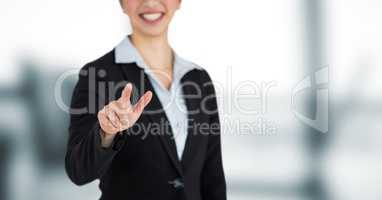 Midsection of businesswoman pointing over blur background