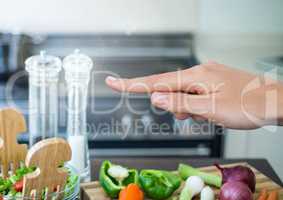 Hand touching air with cooking objects in kitchen