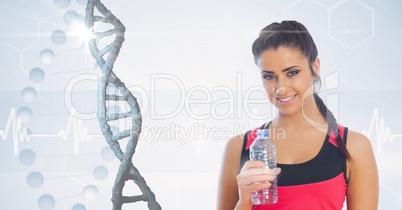 Fit woman holding water bottle against DNA structure