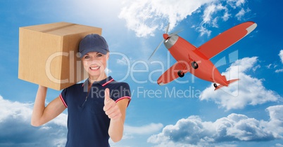 Delivery woman with parcel gesturing thumb up against airplane flying in sky