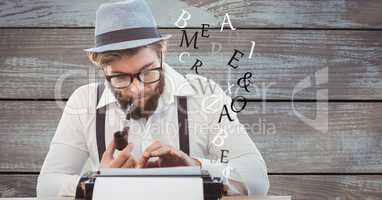 Hipster using typewriter while smoking pipe against wooden wall