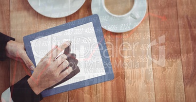 Hands using digital tablet at table