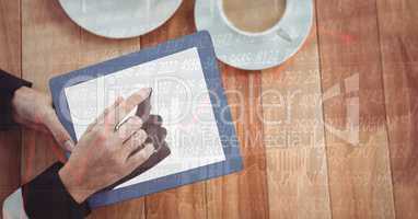 Hands using digital tablet at table
