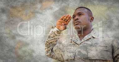 Soldier saluting against blurry map with grunge overlay