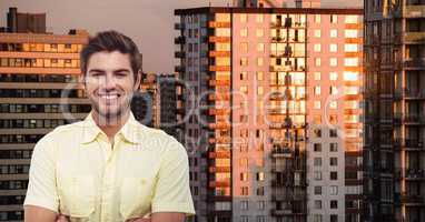 Businessman smiling against buildings in city