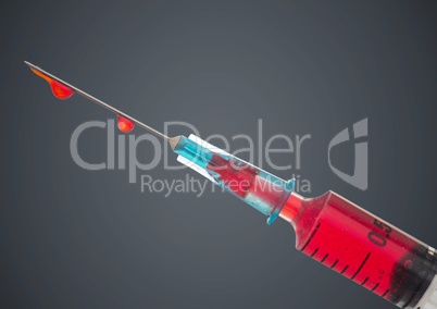 Syringe with red liquid against grey background