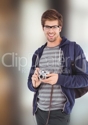 Portrait of happy male hipster holding camera