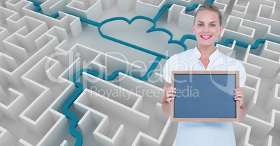Smiling businesswoman holding slate against cloud connecting in maze