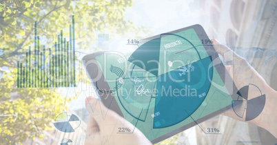 Hands holding digital tablet with pie chart overlay