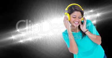 Happy woman listening to music against lights