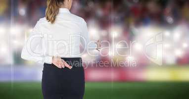 Rear view of businesswoman with fingers crossed offering handshake