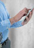 Midsection of businessman using tablet PC