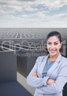 Businesswoman with arms crossed against maze