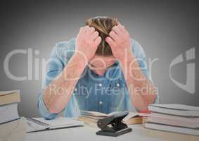 Man stressed at desk against grey background