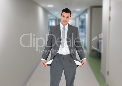 Confident businessman showing empty pockets