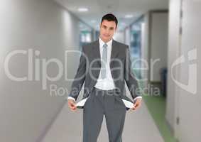 Confident businessman showing empty pockets