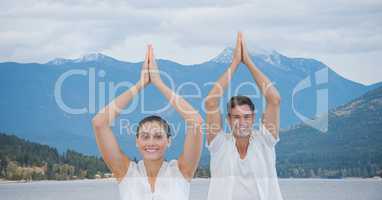 Double exposure of man and woman against mountains