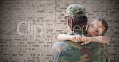 Back of soldier with daughter against brown brick wall