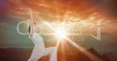 Double exposure of woman with arms raised against sky during sunset