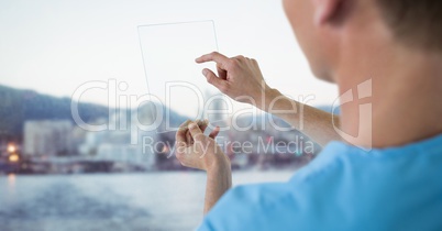 Doctor touching glass device against blurry skyline