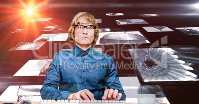 Digital composite image of hacker with screens