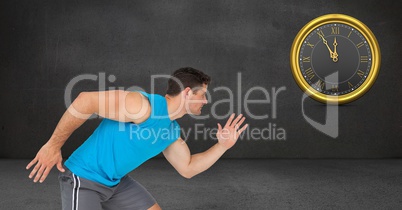 Sporty man running while looking at clock on wall