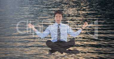 Double exposure of businessman doing yoga over sea