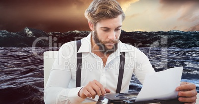 Hipster using typewriter against lake