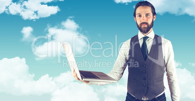 Hipster holding laptop against sky
