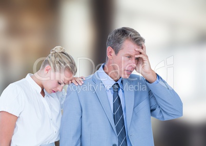 Depressed business people against blurred background