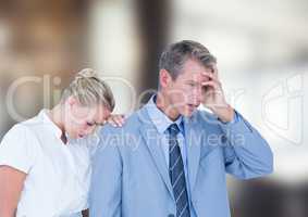 Depressed business people against blurred background