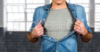 Midsection of man tearing shirt