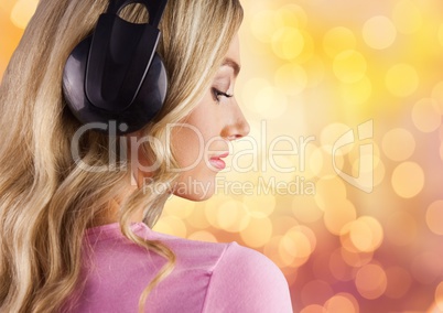 Woman wearing headphones over bokeh