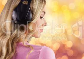 Woman wearing headphones over bokeh