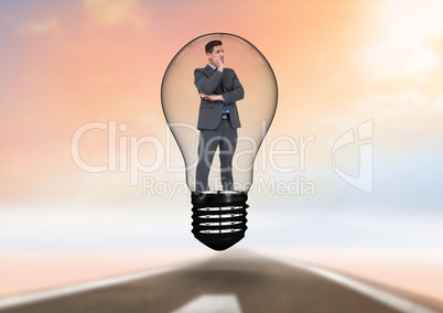 Businessman standing in light bulb