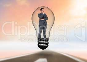 Businessman standing in light bulb