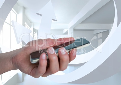 Hand holding a mobile phone and minimal white room with swerving arrows